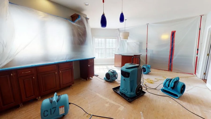 Four turbo drying fans and a dehumidifier set up by Omaha Water Restoration in the kitchen of a home damaged by water in Waterloo, NE.